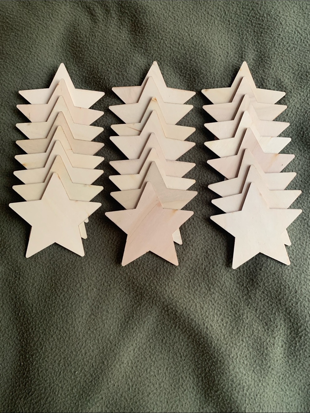 Set of 24 unfinished wood star cutouts. Approximately 4”.